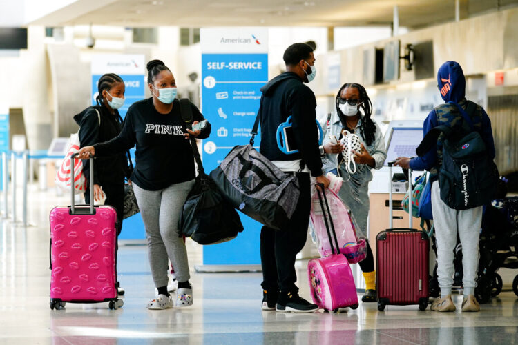 Travelers wearing protective masks as a precaution against the spread of the coronavirus move about the a terminal at the Philadelphia International Airport in Philadelphia, Tuesday, April 19, 2022.  A federal judge's decision to strike down a national mask mandate was met with cheers on some airplanes but also concern about whether it's really time to end one of the most visible vestiges of the COVID-19 pandemic. (AP Photo/Matt Rourke)