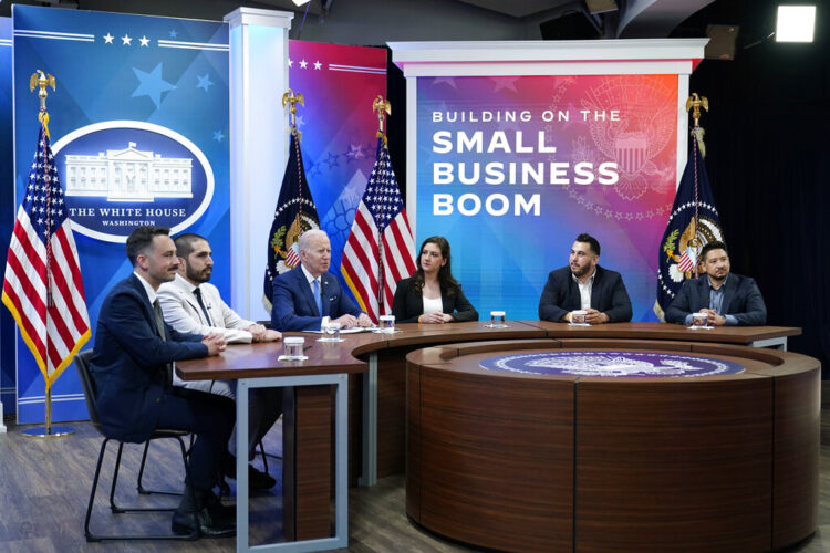 President Joe Biden, third from left, speaks as he meets with small business owners in the South Court Auditorium on the White House complex in Washington, Thursday, April 28, 2022. Joining Biden is, from left, Jeff Yerxa, co-founder of Lost Sock Roasters, Nicolas Cabrera, co-founder of Lost Sock Roasters, Jennifer Arniella, owner of Unique Crafts by Jenn, Edward Garcia III, co-founder of The Box Street Social, and Daniel Trevino, co-founder of The Box Street Social. (AP Photo/Susan Walsh)
